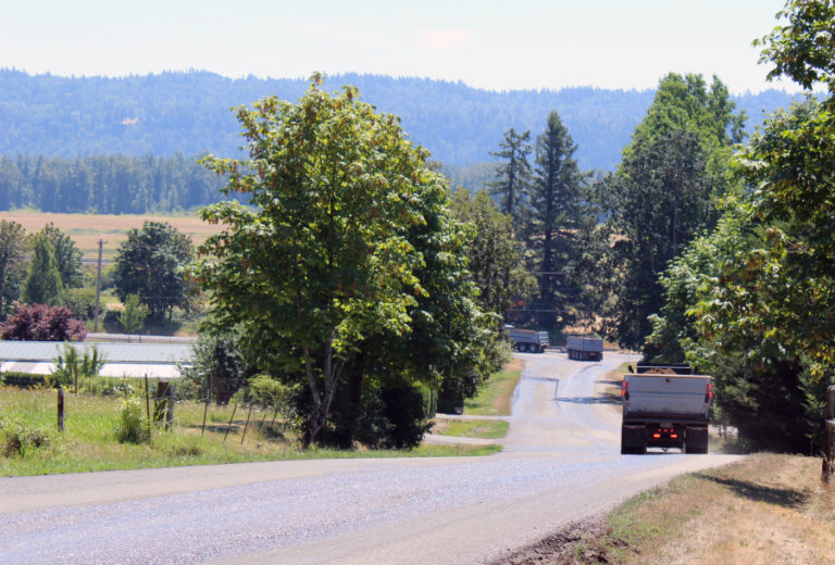 Trucks hauling material from a Washougal rock quarry in the Columbia River Gorge National Scenic Area turn from Southeast 356th Avenue onto Evergreen Highway on July 24, just five days after a truck coming from the rock quarry lost control and crashed onto railroad tracks across Evergreen Highway. Neighbors of the mine, as well as the Friends of the Columbia River group, worry about environmental, health and safety hazards posed by the quarry's mining operations and related truck traffic.
