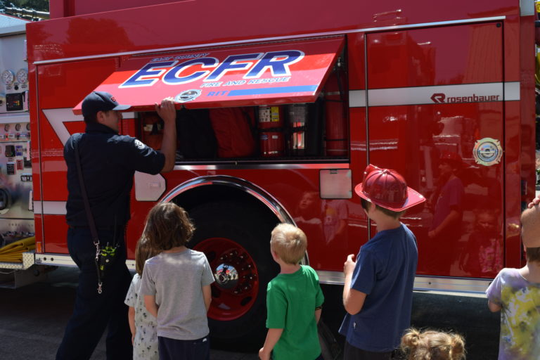East County Fire and Rescue fireman gives children a tour of a fire engine during the ECFR open house, Sunday, July 29.