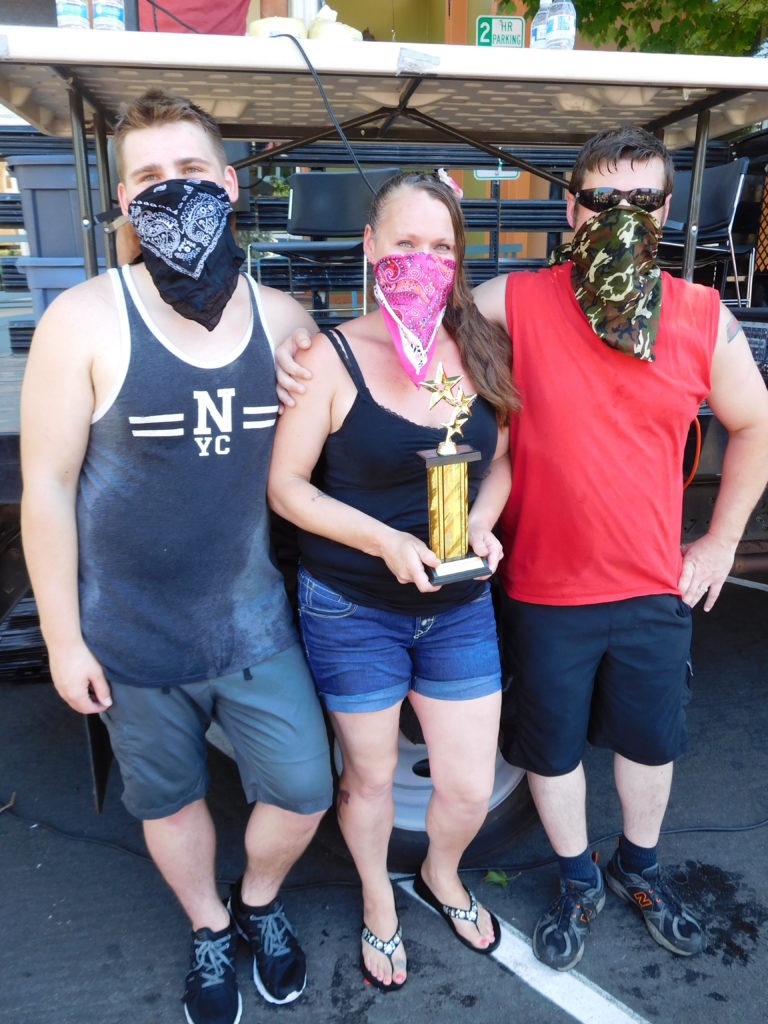 The "Bathtub Bandits," consisting of Triston Groth (left) and his parents, Tanya Groth and Greg Irwin, win first place in the Camas Days bathtub race competition Saturday, July 28. The team has earned third place or better for 13 years.