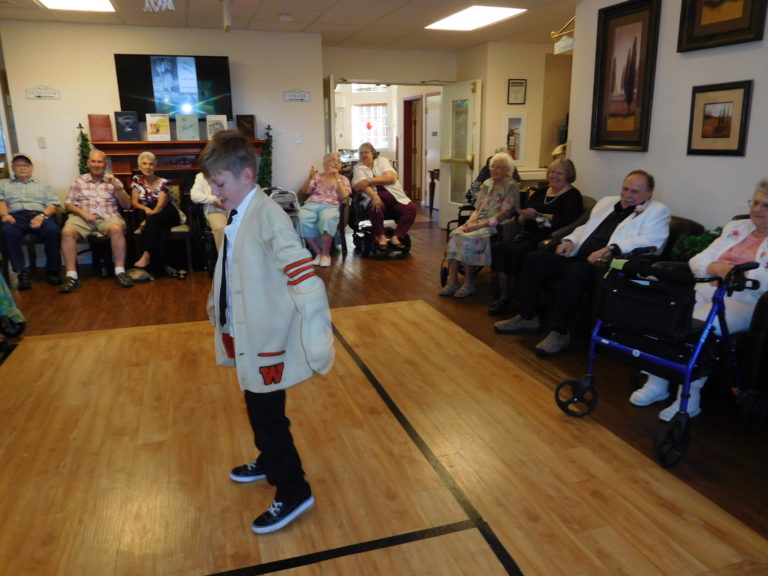 Jaxon Anderson, grandson of Columbia Ridge Senior Living Executive Director Lori Anderson, shows some of his dance moves during the Columbia Ridge Senior Prom Thursday, July 26. Jaxon wore a 1964 Washougal High School letterman’s sweater owned by Columbia Ridge Maintenance Director Bill Dade.