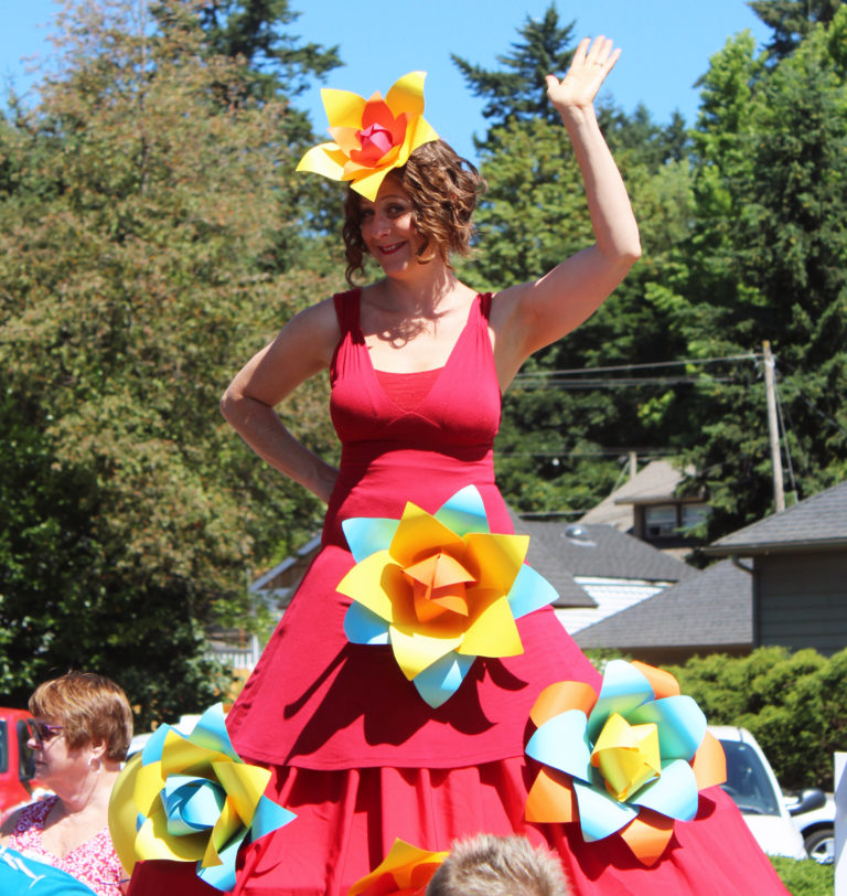 A stiltwalker waves from above the crowds at the 2018 Camas Days Kids Parade on Friday, July 27.