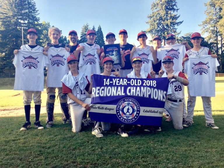 The Hit Squad from Woodland display their championship banner and T-shirts at Camas' Louis Bloch Park on Saturday, July 28. The Clark County team now heads to Eagle Pass, Texas, to play in the Babe Ruth World series on Aug.