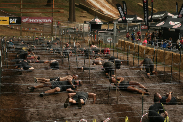 The challenging barbed wire obstacle at Washougal MX park is built on top of bumpy, muddy moguls that are typically used for motocross racing.