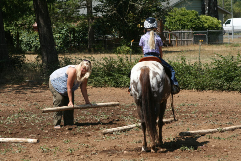 Mamie Wheeler (left) sets up an obstacle for her 8-year-old daughter, Aubrie, at the family farm near Fern Prairie in Camas.