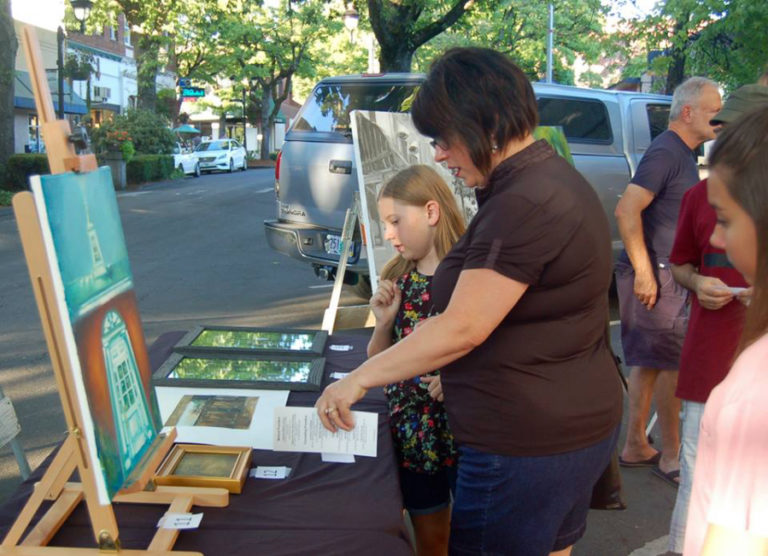 Gina Mariotti Shapard and her daughters vote for "People's Choice" awards during Camas' 2017 Plein Air art event in September 2017. This year's Plein Air show will be held throughout the day, Friday, Sept.
