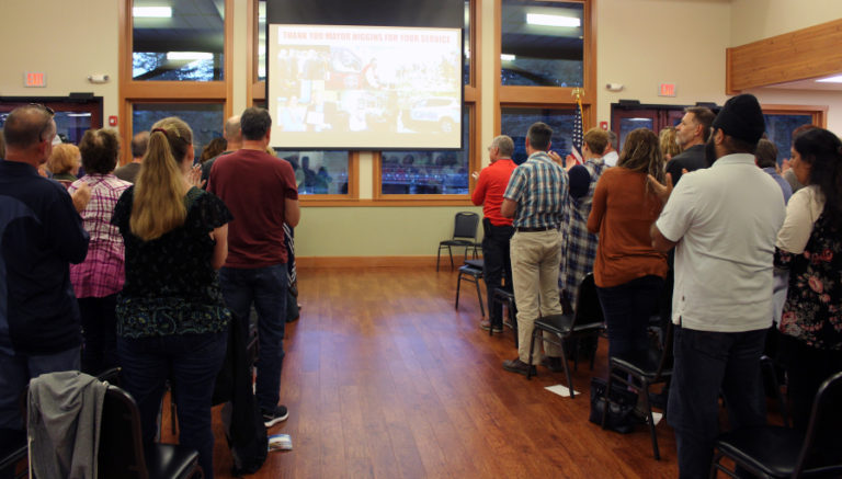 Community members stand to applaud Camas Mayor Scott Higgins (not pictured) at the Sept.
