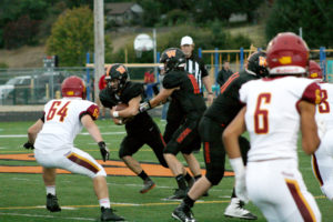 The Panthers Brevan Bea takes a handoff from quarterback Dalton Payne against Prairie High, Sept. 29.  Bea and Peter Boylan share the running back position and push each other hard in practice when Bea plays defense. 