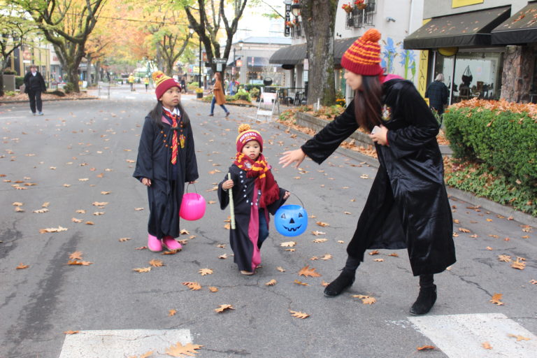 A Hogwarts family makes their way down Northeast Fourth Avenue in Camas during the 2018 Boo Bash, on Wednesday, Oct. 24. Pictured: Mom Kelly (right) with her two children, Julamani, 6 (left), and Jameson, 3 (center).