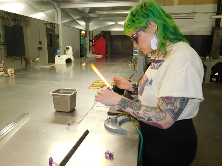 Stephanie Carmichael, of Portland, makes a pendant at the Washougal-based Mary Jane's Glass Productions.