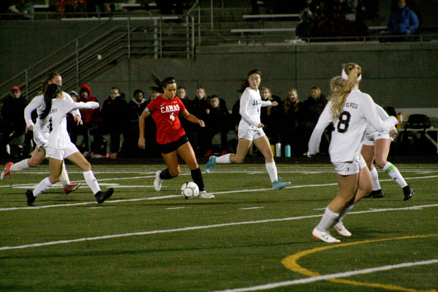 Even with a pained hamstring, Maddie Kemp manages to weave through the Jackson team at Doc Harris Stadium. The Papermakers are heading for their fourth consecutive appearance at the state semifinals.
