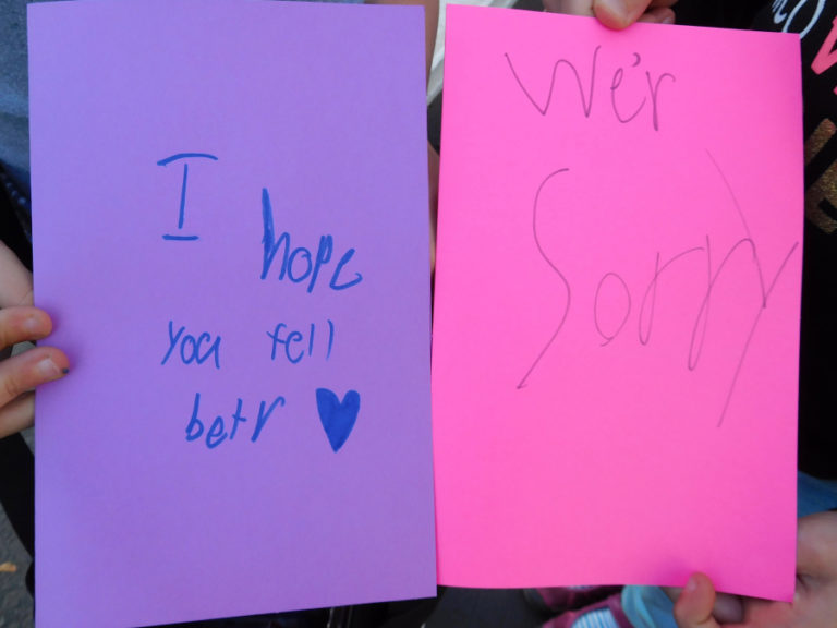 Jocelyn and Genevieve Sandrin, 8, of Camas, bring notes for people in Northern California devastated by wildfires, to a donation site in the Lutz Hardware parking lot, in Camas.