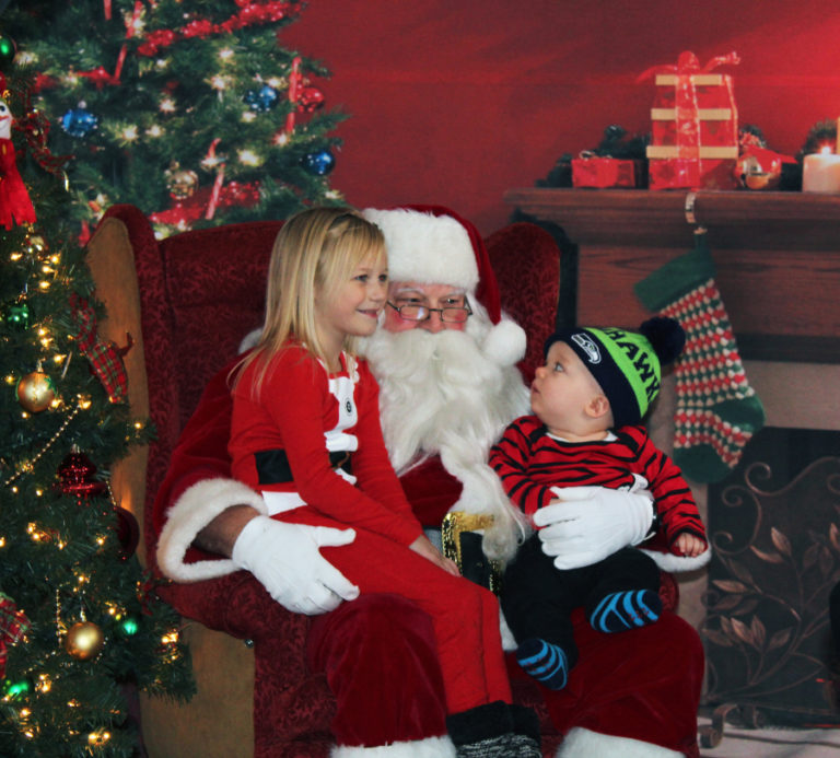 Above, Santa greets children at the 2017 Hometown Holidays celebration in downtown Camas. At right, Camas city staff put this year's Hometown Holidays tree up in downtown Camas this week. Camas Mayor Shannon Turk will light the tree during the annual holiday celebration on Friday, Dec. 7.
