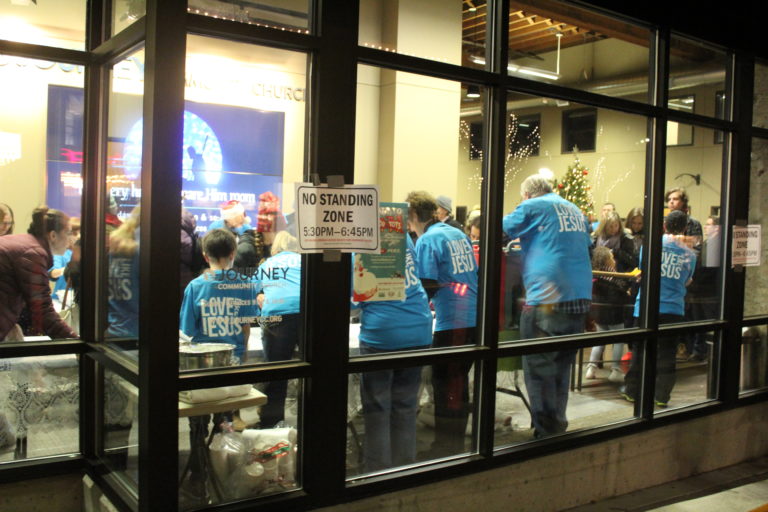 Journey Church volunteers serve their famous free hot cocoa during the annual Hometown Holidays celebration in Camas, on Friday, Dec. 7.