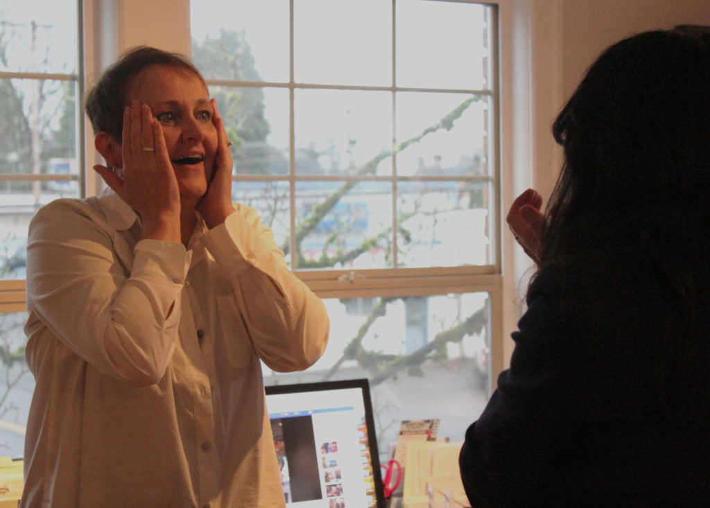 Carrie Schulstad, executive director of the Downtown Camas Association, reacts to the news that Camas has made the top 10 in a competition for a $500,000 downtown business makeover on the fourth season of 