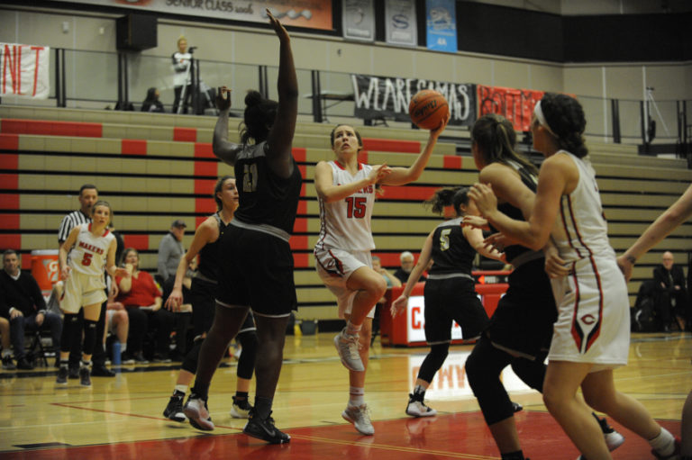 Camas senior Katie Hancock goes to a left-handed hook shot to shoot over 6&#039; 4&quot; Aaronette Vonleh from West Linn High School.