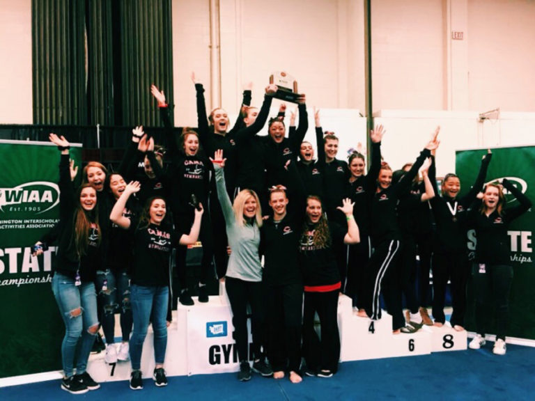 Camas High gymnasts celebrate their team's first state championship win on Feb. 16, 2018.