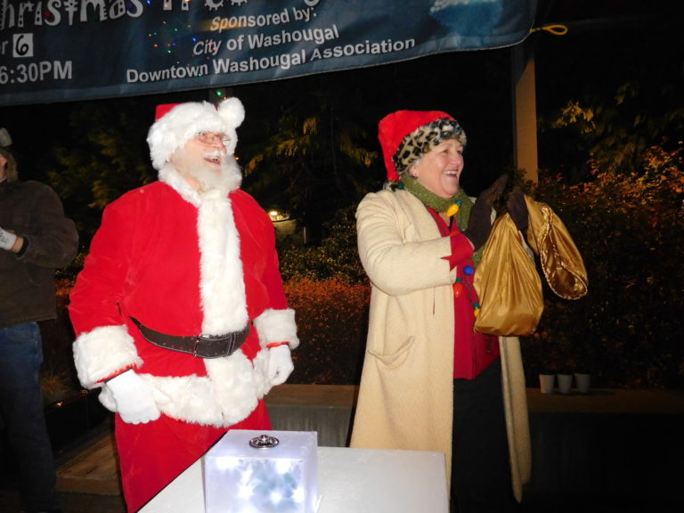 (Dawn Feldhaus/Post-Record) Santa Claus and Washougal Mayor Molly Coston celebrate the lighting of the Christmas tree in Reflection Plaza, Dec. 6.