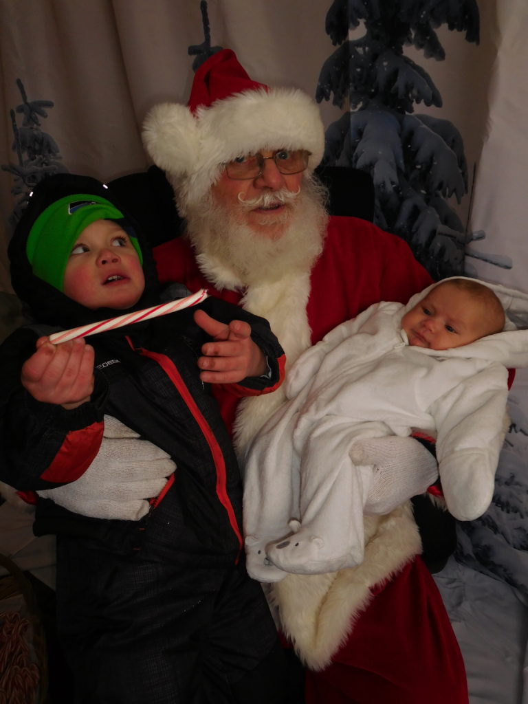 (Dawn Feldhaus/Post-Record) Brayden Lawrence and Macee Kratzke visit with Santa Claus, in Washougal, Dec. 6, after the Christmas parade and lighting of the Christmas tree in Reflection Plaza.