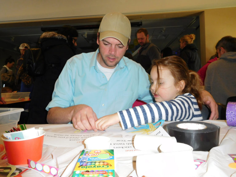 Josh Stahly and his daughter, Lydia Stahly, 4, of Vancouver, make a mask and balloon popper during the &quot;Noon Year&#039;s Eve&quot; party, Monday, Dec. 31, at the Camas Public Library.