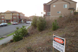 A "Danger" sign, located near the Lookout at the Ridge apartment complex in Washougal, leads to a blasting site for a new subdivision. Blasting to remove rock for underground utilities was put on hold after a rock, allegedly from the blasting site, crashed through a roof and landed in a child's bedroom. No one was in the room at the time. 