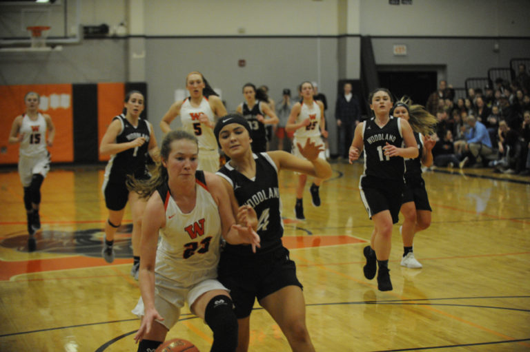 Washougal freshman guard Sammy Mederos (left) is fouled during a fast break against Woodland High on Jan.