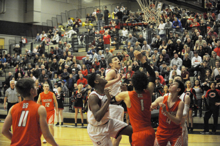 Camas senior Isaiah Sampson (left) and junior Jackson Clemmer (middle) fight for rebounding position in overtime against Battle Ground on Jan.