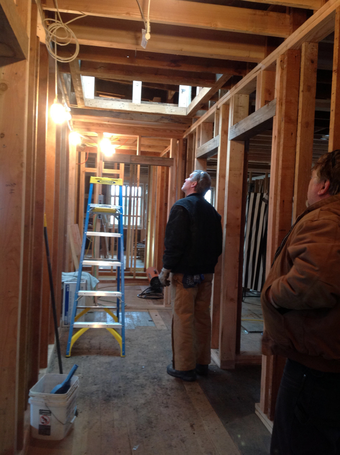 Bruce Kramer (left) and Mark Nichols (right) look toward a skylight in the Blair Building in December 2016. They cut a four-by-four foot hole in the roof, to accommodate the installation of the skylight.