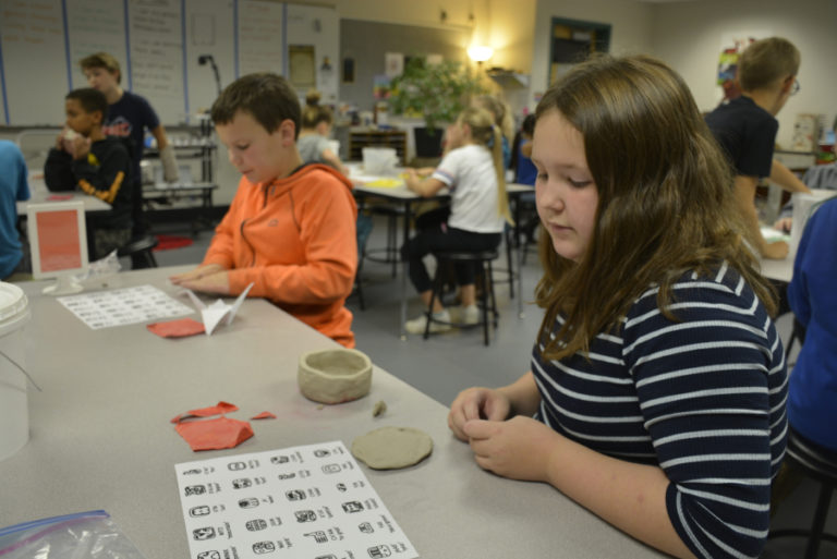 Cape Horn-Skye Elementary School students Preston Tolbert (left) and Juliet Collins (right) create artwork in class.