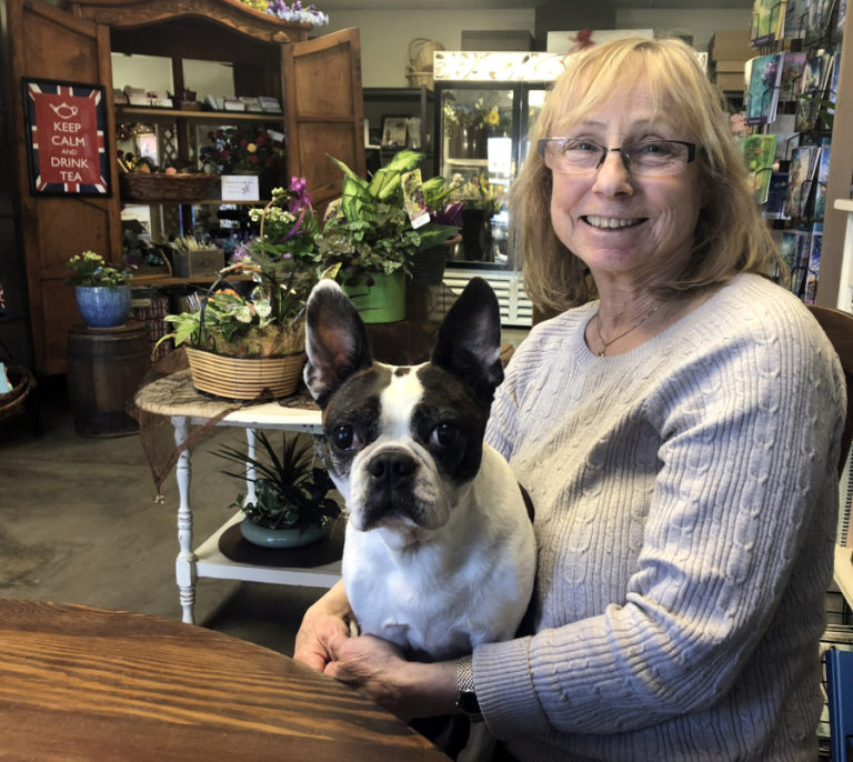 Sandy Bakker, the founder of Coventry Gardens of London, sits inside her daughter, Rachel Bakker's, new floral design studio with Rachel's 12-year-old dog, Coco, on Friday, March 1.