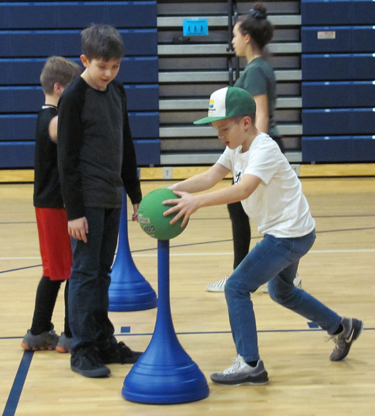 Owen Minnis (right) performs an agility exercise with Jacob Benson watching during Washougal School District's Family Fitness event.