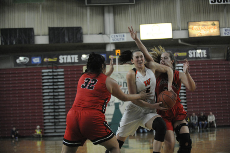 Grit, drive and determination can be seen on the face of Beyonce Bea as she splits a double team during the semi final game against Clarkston.