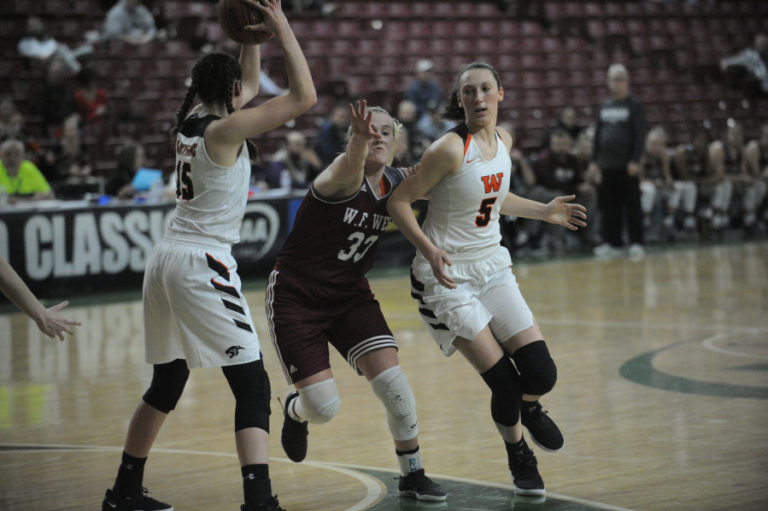 Beyonce Bea makes a cut while her younger sister Skylar looks to pass the ball from the post position.