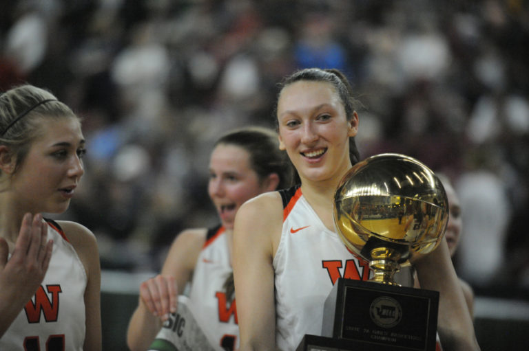 The celebration begins as Beyonce Bea shows off the state championship trophy to her teammates.