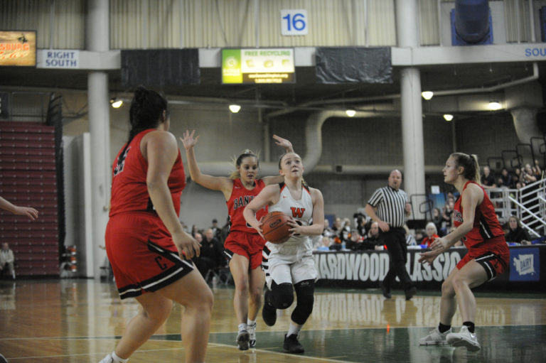 Senior guard Kiara Cross attacks the hoop in the semi final game against Clarkston.