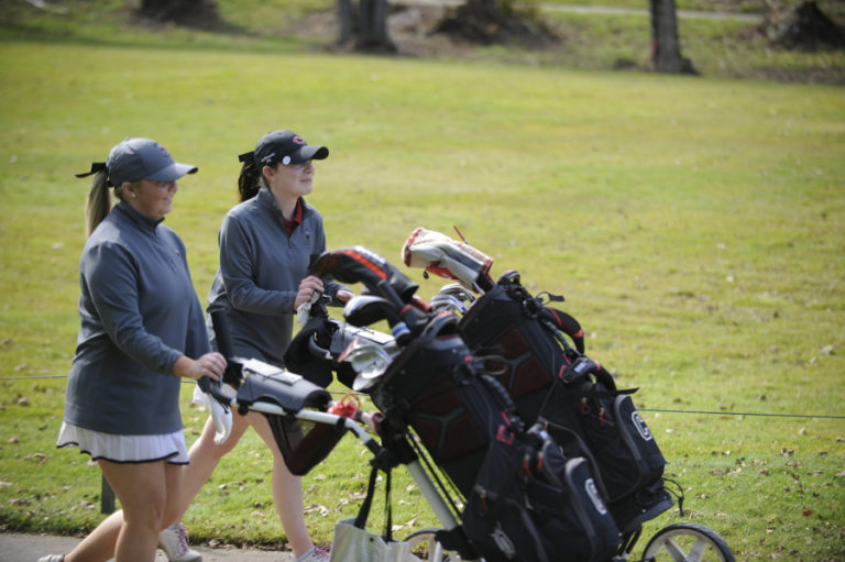 Seniors Ashley Clark and Emma Cox walk together during a recent match against Heritage at Camas Meadows.