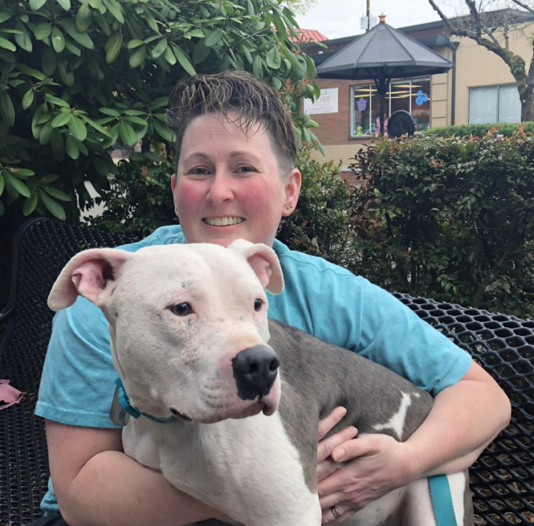 Pam Maxey holds Joey the pitbull in downtown Camas on April 12. Maxey, of Camas, recently wrote a children's book telling Joey's rescue story from his perspective.