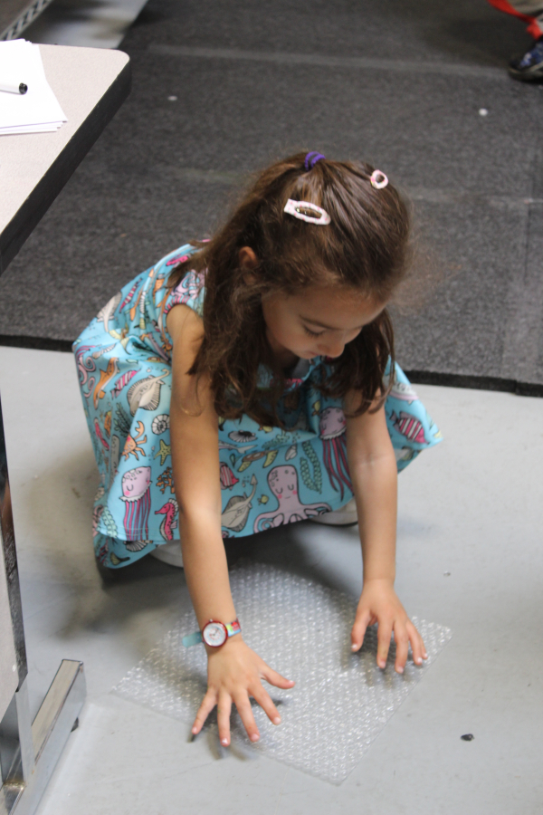 Zoe Verzwyvelt, 5, plays with bubble wrap at the Camas headquarters of SIGMADESIGN, a product development and engineering firm, on April 25, for the company&#039;s fifth annual &quot;Take Your Child to Work&quot; event.