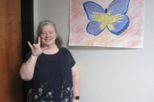 Washougal High School American sign language teacher Tami Blair signs "I love you" in her classroom on April 24. 