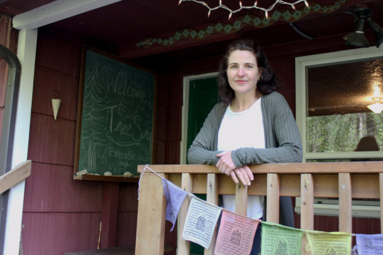 Vancouver artist Sam Marroquin stands on the Washougal-based TreeSong Nature Awareness and Retreat Center&#039;s porch.