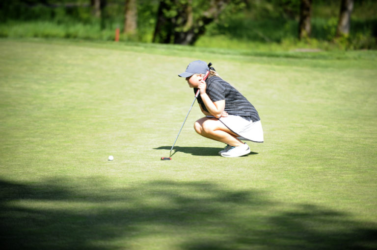 Camas senior Ashley Clark lines up a put during the final league match of the year against Battle Ground on April 30.