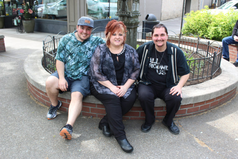 Director Tristan David Luciotti (left) sits in downtown Camas with the star of his film "All Around Us," Seth Michael (right) and Michael's girlfriend Jyl Straub (center), of The Wild Hair salon in Camas.