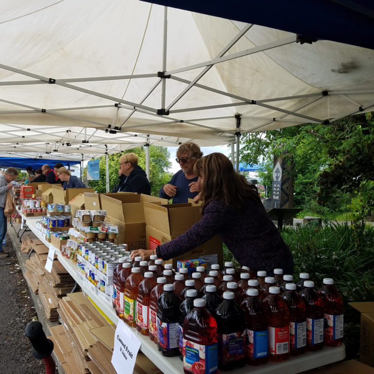 Volunteers help pack food boxes at a 2018 Impact Camas-Washougal event.