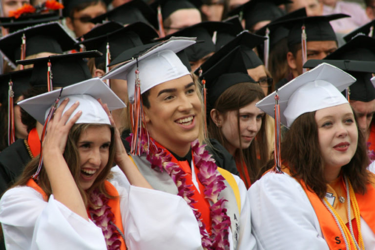 Hunter Harris (second from right), an enlistee in the U.S. Army, watches fellow Hayes Freedom graduates receive their diplomas on Saturday, June 16, at Liberty Middle School.