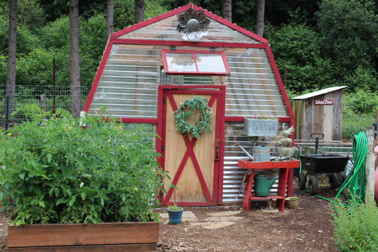 A greenhouse at Shangri-La Farm is partially made of old campaign signs.