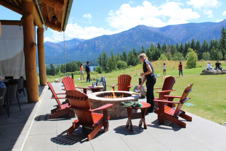 A Skamania Lodge employee clears glasses from tables near one of two outdoor firepits available at the lodge's new Riverview Pavilion on June 27.