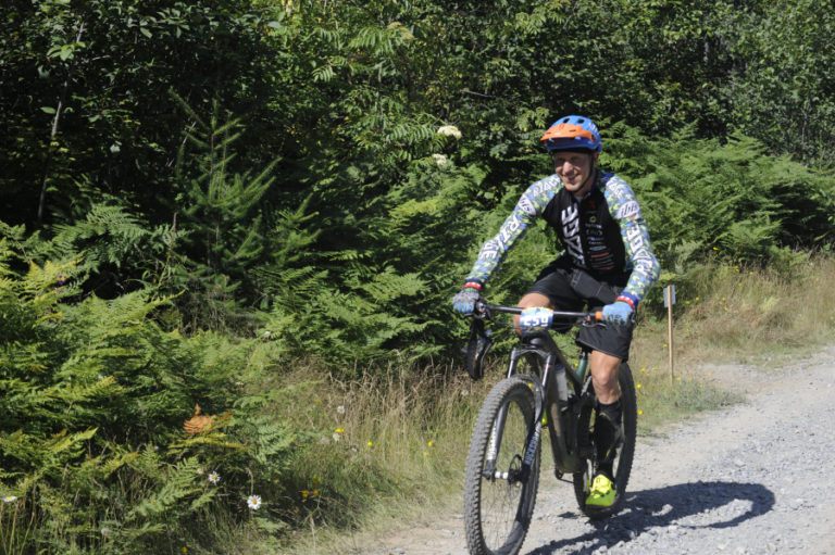 Evan Plews, a bike shop owner and professional racer from Wenatchee, climbs up Larch Mountain to the next stage of the race.