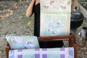 Washougal resident Heather Farris displays a selection of her hand-made quilts, some of which will be up for sale at the River Art Fair in Washougal on Saturday, Aug. 3. (Doug Flanagan/Post-Record)