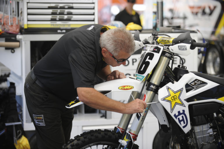 Dave Feeney, a mechanic for professional rider Zach Osbourne, makes a few suspension adjustments to prepare for what he calls the  the "slippery nature" of the Washougal dirt.
