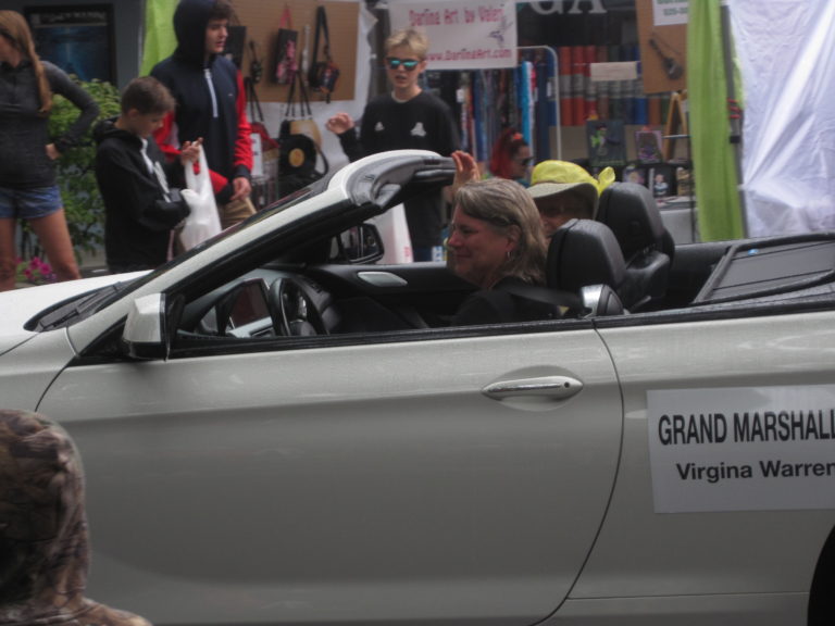 Camas Days Grand Marshall Virginia Warren (yellow hat) waves to onlookers during the Camas Days Grand Parade on Saturday, July 27.