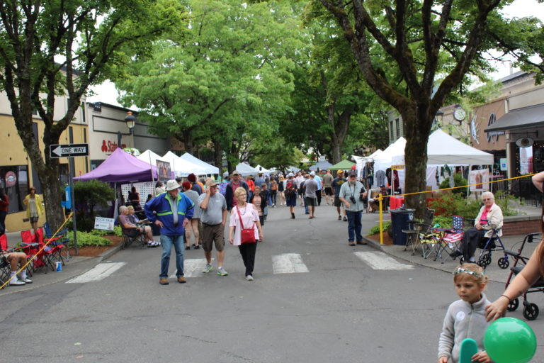 Camas Days attendees walk up and down 4th Avenue in downtown Camas before the start of the Grand Parade on Saturday, July 27.